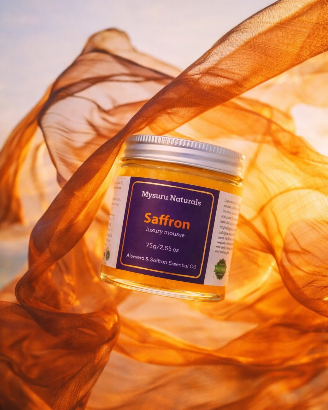 Jar of mysuru naturals saffron luxury mouse on a draped fabric background